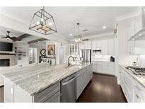 Spacious eat-in kitchen with large center island, stainless appliances, and modern lighting at 2903 Eva Clb, Acworth, GA 30101