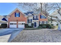 Beautiful two-story home boasts brick and siding exterior, two-car garage, and well-maintained landscaping at 3202 Monarch Pine Dr, Peachtree Corners, GA 30071