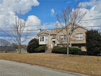 Charming two-story brick home with well-manicured landscaping and inviting entrance at 3885 Laurens Ln, Snellville, GA 30039