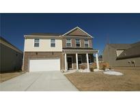 Two-story home with brick and siding exterior, two-car garage, and landscaped front yard at 1603 Maston Rd, Auburn, GA 30011