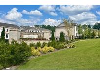 Beautiful landscaping and stone signage welcome you to Wards Crossing Townhome community at 169 Ward