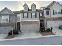 Traditional townhome with two car garage and double windows, nestled in a vibrant community at 5008 Whiteoak Pointe Se # 15, Smyrna, GA 30080