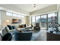 Bright living room with large windows and a sliding glass door to a balcony at 1100 Howell Mill Nw Rd # 708, Atlanta, GA 30318