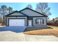 Charming single-story home with a two car garage, stylish siding, and well-maintained landscaping at 96 Wheelers Dr, Dallas, GA 30157