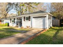 Charming single-story home with a brick-lined driveway and well-maintained front lawn at 2886 Salmon Se Ave, Atlanta, GA 30317