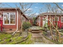 Charming backyard with brick pathway, patio, and lush greenery offers a serene outdoor living space at 698 Bellemeade Nw Ave, Atlanta, GA 30318