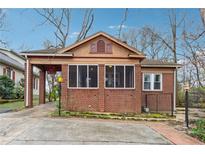 Charming brick home featuring a covered carport and screened-in porch perfect for relaxing outdoors at 698 Bellemeade Nw Ave, Atlanta, GA 30318