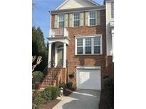 Charming brick home featuring a small front porch, two stories and an attached one car garage at 201 Balaban Cir, Woodstock, GA 30188