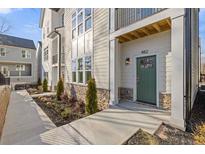 Beautiful new construction home with a green front door, stone accents and landscaped yard at 482 Hammons Way, Atlanta, GA 30315