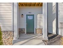 Inviting front entrance with a green door, stone accents, and modern lighting fixture at 482 Hammons Way, Atlanta, GA 30315