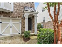 Charming brick townhouse featuring a covered entryway and attached one car garage at 6080 Indian Wood Se Cir, Mableton, GA 30126