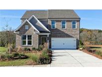 Charming two-story home with a brick facade, well-manicured lawn, and an attached two-car garage at 610 Belshire Dr, Acworth, GA 30102