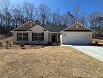Charming single-story home with a brick facade, two-car garage, and manicured front yard at 5311 Tuscany Drive, Douglasville, GA 30135