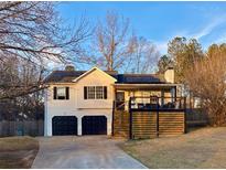 Charming home featuring a garage and modern deck in a residential neighborhood at 71 Riverside Ct, Douglasville, GA 30134