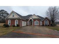 Beautiful single-story brick home with an arched entryway and side-entry garage at 1205 Peeksville Rd, Locust Grove, GA 30248