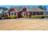 Beautiful, single-story brick home featuring manicured landscaping and a well-maintained lawn at 811 Weeping Willow Dr, Powder Springs, GA 30127