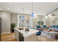 Bright kitchen with stainless steel appliances, island with quartz countertops, and an open floor plan at 1029 Piedmont Ne Ave # 101, Atlanta, GA 30309