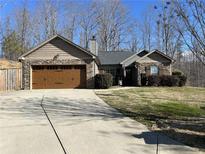 Charming home featuring a stone and shingle facade, attached garage, and a well-maintained front yard at 101 Flagler Way, Dallas, GA 30157
