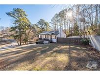 Charming home with a well-maintained front yard and a classic white facade, complemented by mature trees at 2571 Hamill Dr, Buford, GA 30519