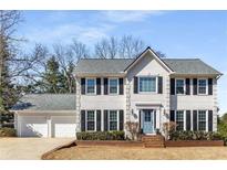 Charming two-story home features a manicured front yard and a two-car garage at 2999 Timberlea Lake Se Way, Marietta, GA 30067