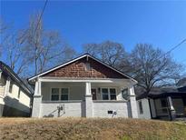 Charming home featuring a cozy porch with painted brick and detailed trim at 1575 Montreat Pl Sw Pl, Atlanta, GA 30311