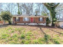 Charming single-story brick home with a red front door and well-maintained landscaping at 3119 Bellgreen Way, Decatur, GA 30032