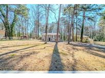 Charming home featuring a well-maintained yard, mature trees, and a classic facade at 3524 Exeter Ct, Snellville, GA 30039