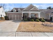 Charming single-Gathering home with a brick facade, two-car garage, covered porch, and well-maintained lawn at 131 Riverside Ln, Woodstock, GA 30188