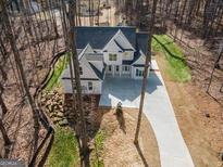 Stunning new construction home featuring a long driveway and a private, wooded lot at 255 Olde Oak Dr, Jonesboro, GA 30238