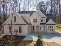 Charming two-story home with attached garage and inviting front entrance nestled in a wooded lot at 255 Olde Oak Dr, Jonesboro, GA 30238