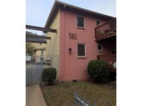 Pink and yellow two-story building with balconies and gated entry offers appealing urban living at 561 Formwalt Sw St # 12, Atlanta, GA 30312