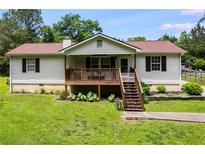 Charming home featuring a inviting front porch, green lawn, and classic design at 2960 Paul Harris Rd, Dallas, GA 30157
