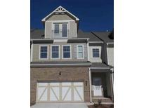 Charming townhome showcasing a brick facade and a private balcony at 1935 Manor Pointe Dr, Cumming, GA 30041