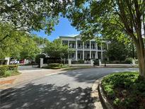 Elegant home featuring a brick driveway and a manicured lawn at 3980 Saint Elisabeth Sq, Duluth, GA 30096