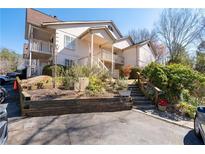 Exterior elevation of a two-story home featuring a charming entrance with well-maintained landscaping at 903 Bridge Se Ln, Smyrna, GA 30082