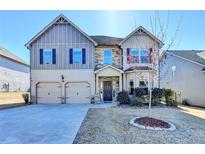 Charming two-story home featuring a well-manicured lawn, two-car garage, and inviting front entrance at 1465 Forest Brook Trl, Cumming, GA 30041