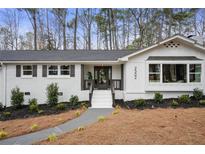 Charming brick home with white paint, black shutters, and a well-maintained landscaped front yard at 2302 Fairoaks Rd, Decatur, GA 30033