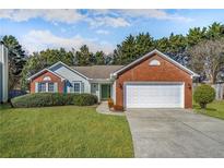 Charming single-story brick home with a well-manicured lawn and attached two-car garage at 4124 Berwick Farm Dr, Duluth, GA 30096