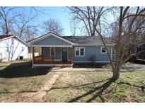 Charming light blue home featuring a cozy front porch and manicured lawn at 127 Marona Ne St, Atlanta, GA 30307
