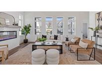 Bright living room with modern fireplace, hardwood floors, multiple windows and stylish neutral decor at 484 Hammons Way, Atlanta, GA 30315