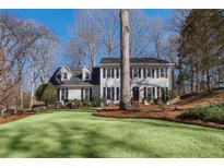 Charming two-story traditional home with black shutters and professionally landscaped front yard at 4172 Westchester Ne Xing, Roswell, GA 30075