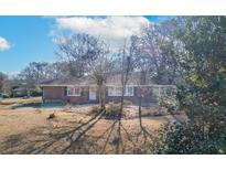 Charming single-story brick home with mature trees and landscaping, offering great curb appeal at 1141 Milstead Ne Ave, Conyers, GA 30012