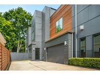 Modern two-story home featuring mixed siding, an attached garage, and a well-maintained lawn at 244 Locust Ne St # B, Atlanta, GA 30317