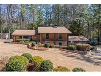 Charming two-story brick home featuring manicured landscaping and a lush, wooded backdrop at 3401 Lori Ln, Atlanta, GA 30340