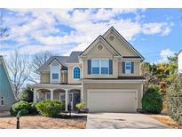 Charming two-story home with blue shutters, a well-manicured lawn, and attached two-car garage at 2230 Rosemoore Walk, Marietta, GA 30062