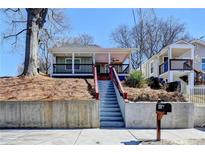Charming bungalow with inviting front porch, and a classic, landscaped yard at 543 Paines Nw Ave, Atlanta, GA 30318