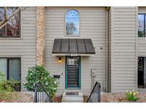Charming home entrance with a well-kept lawn, attractive front door and covered entryway at 3721 Stonewall Se Cir, Atlanta, GA 30339