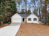 Charming one-story home with white siding, stone accents, and a well-manicured front yard at 2966 Knollberry Ln, Decatur, GA 30034
