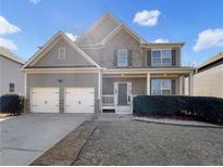 Charming two-story home featuring a stone facade, inviting front porch, and a convenient two-car garage at 610 Collingsworth Ln, Lawrenceville, GA 30043