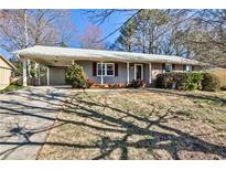 Charming ranch home with a covered carport and a well-maintained front yard at 3549 Creatwood Se Trl, Smyrna, GA 30080